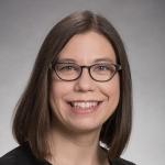 Woman with shoulder length brown hair and eyeglasses.